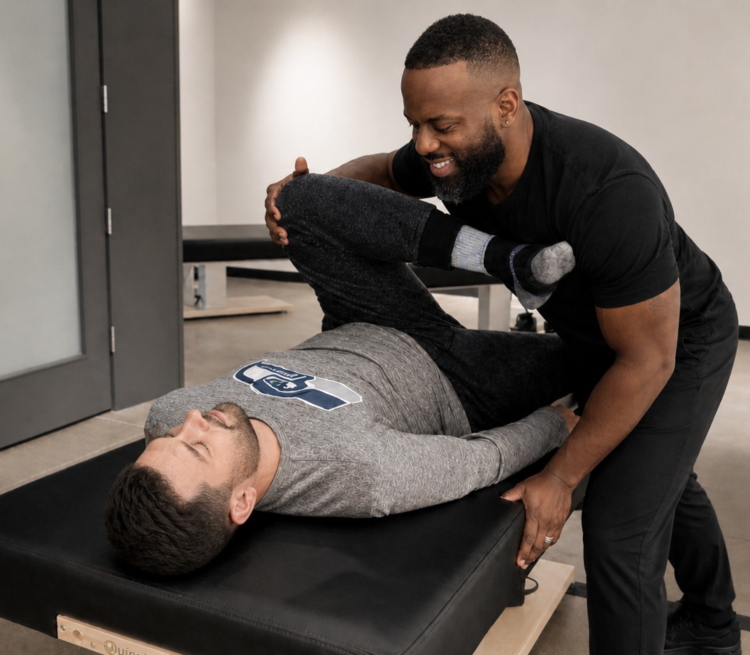 Justin from Slo! Bodywork providing clothed soft tissue therapy treatment
